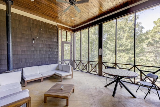 sunroom with outdoor lounge area and a ceiling fan