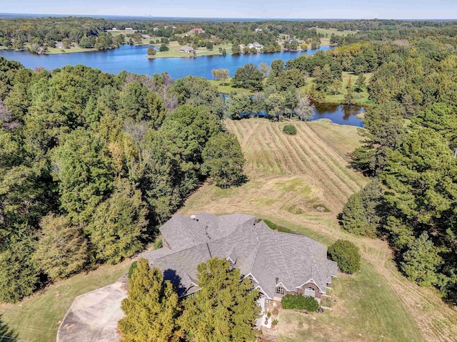 birds eye view of property with a water view and a view of trees