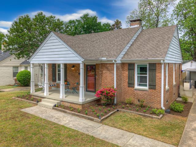 3704 Charleswood Ave, Memphis, TN 38122 - view of front of house with a porch, brick siding, a front yard, and roof with shingles
