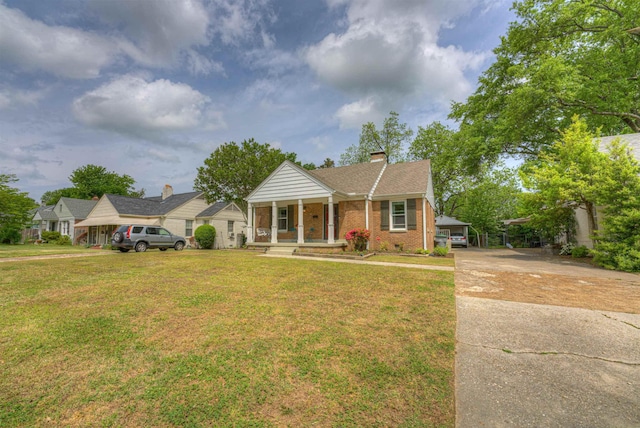3704 Charleswood Ave, Memphis, TN 38122 - view of front of home featuring a porch, brick siding, a front lawn, driveway, and a chimney