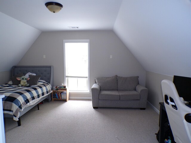 carpeted bedroom with visible vents and lofted ceiling