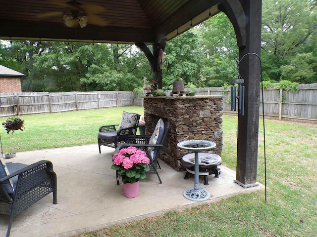 view of patio / terrace featuring an outdoor fire pit, ceiling fan, and a fenced backyard