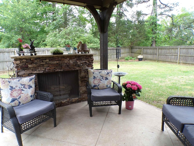 view of patio / terrace featuring a fenced backyard and an outdoor stone fireplace