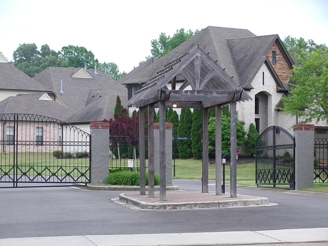 view of property's community with fence and a gate