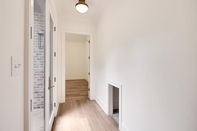 hallway with light wood-style floors and baseboards