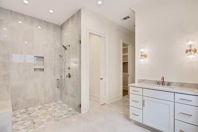 full bath featuring visible vents, a shower stall, marble finish floor, and a spacious closet
