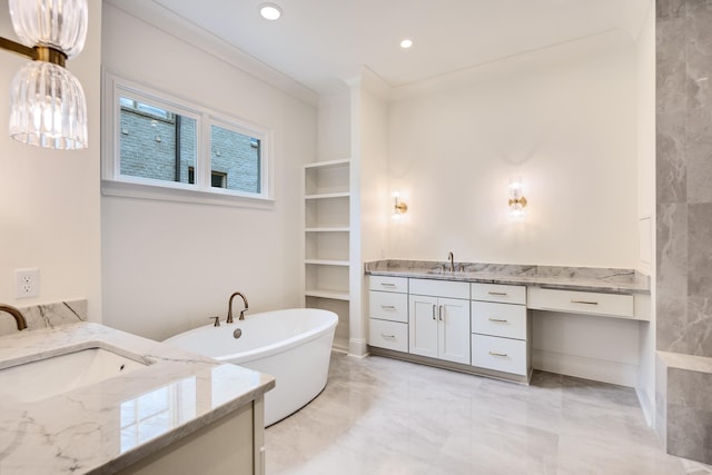 bathroom with crown molding, a sink, marble finish floor, a freestanding tub, and two vanities