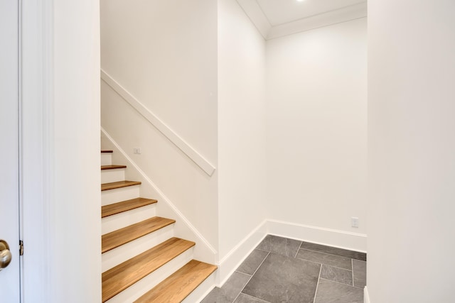 staircase featuring baseboards