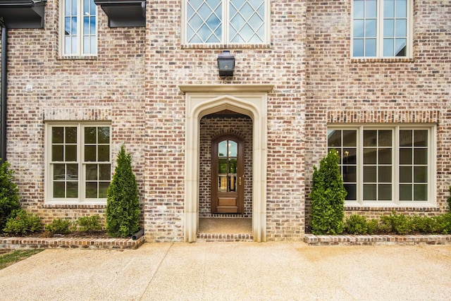 doorway to property with brick siding