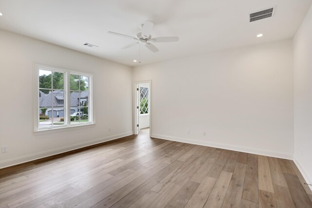 unfurnished room with ceiling fan, visible vents, baseboards, and light wood-style floors