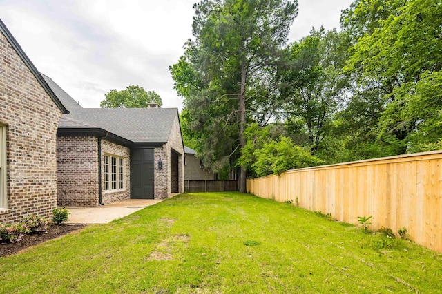 view of yard with a patio and a fenced backyard