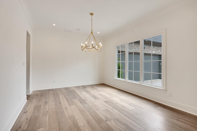 empty room featuring baseboards, a notable chandelier, ornamental molding, recessed lighting, and light wood-style flooring