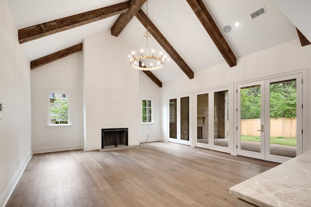 unfurnished living room with a notable chandelier, high vaulted ceiling, french doors, beamed ceiling, and visible vents