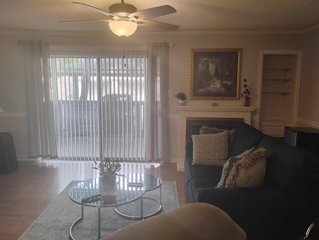 855 Creekside St Unit 303, Memphis, TN 38117 - living room featuring a brick fireplace, a ceiling fan, baseboards, and wood finished floors