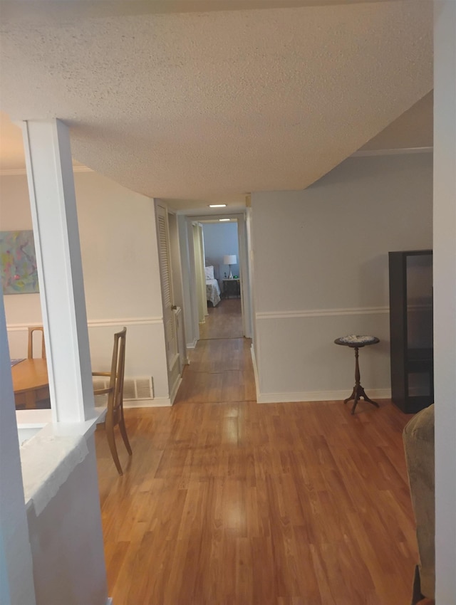 855 Creekside St Unit 303, Memphis, TN 38117 - hall featuring baseboards, visible vents, a textured ceiling, and wood finished floors