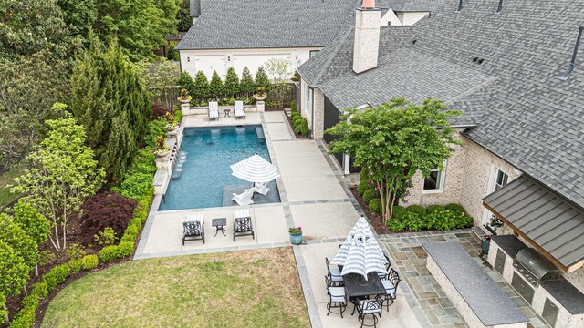 view of pool with a fenced backyard, a patio, and outdoor dining area