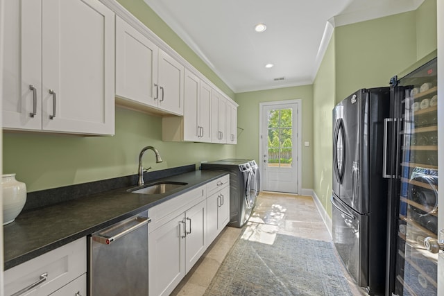 washroom featuring crown molding, washing machine and dryer, cabinet space, recessed lighting, and baseboards