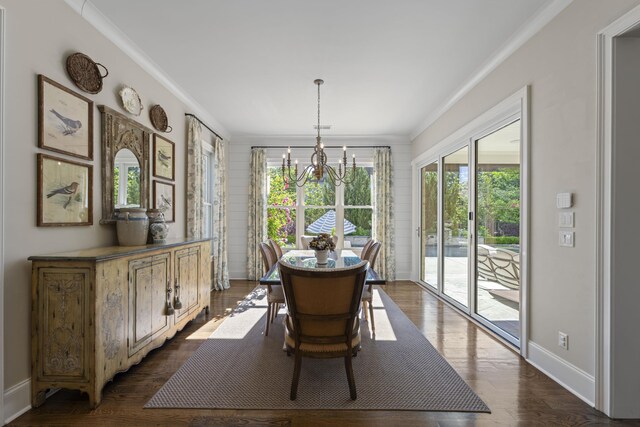 dining area with a chandelier, ornamental molding, baseboards, and dark wood-style flooring