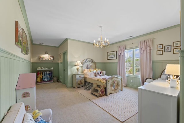 bedroom with a wainscoted wall, crown molding, a chandelier, and light colored carpet