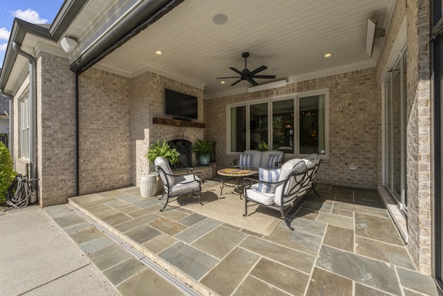 view of patio with ceiling fan and an outdoor living space with a fireplace