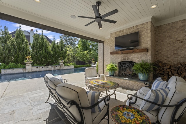 view of patio featuring an outdoor brick fireplace, a ceiling fan, and an outdoor pool