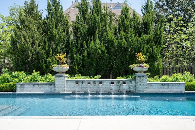 outdoor pool featuring fence