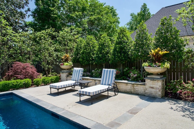 view of pool featuring a patio area and fence