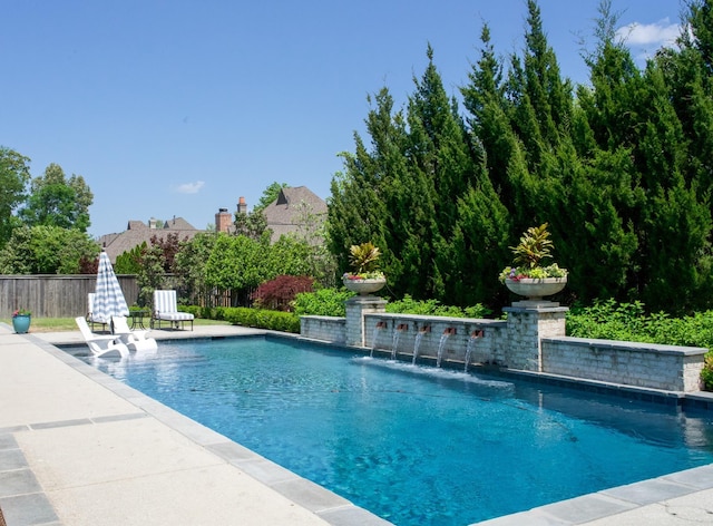 view of pool with fence and a patio