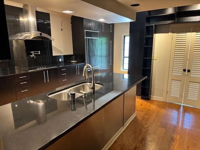 kitchen featuring light wood-style floors, modern cabinets, recessed lighting, black electric cooktop, and a sink