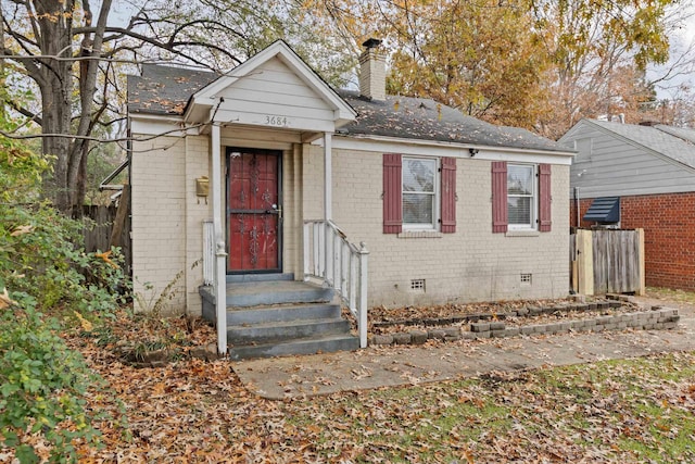 3684 Marion Ave, Memphis, TN 38111 - view of front facade featuring brick siding, crawl space, fence, and a chimney