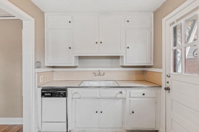 3684 Marion Ave, Memphis, TN 38111 - kitchen with a sink, white cabinetry, dishwasher, and light countertops