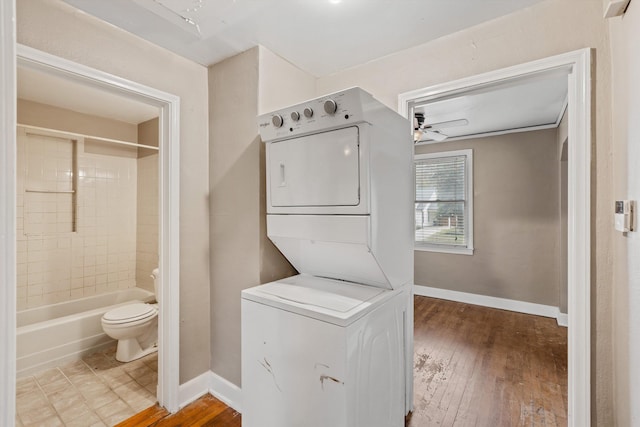 3684 Marion Ave, Memphis, TN 38111 - laundry room with laundry area, attic access, stacked washer / drying machine, baseboards, and hardwood / wood-style floors