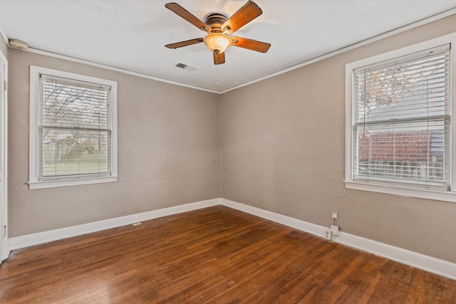 3684 Marion Ave, Memphis, TN 38111 - empty room with baseboards, visible vents, dark wood-style floors, and a healthy amount of sunlight
