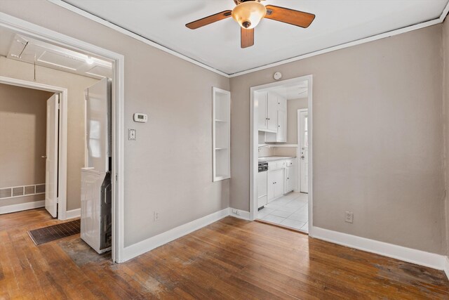 3684 Marion Ave, Memphis, TN 38111 - empty room featuring crown molding, ceiling fan, baseboards, and light wood-style floors