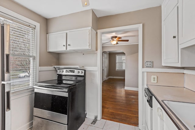 3684 Marion Ave, Memphis, TN 38111 - kitchen with white cabinetry, ceiling fan, a wealth of natural light, and stainless steel range with electric cooktop