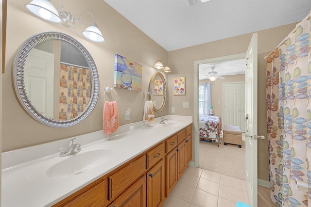 165 Ping Hill Dr, Counce, TN 38326 - ensuite bathroom featuring double vanity, tile patterned floors, a ceiling fan, and a sink