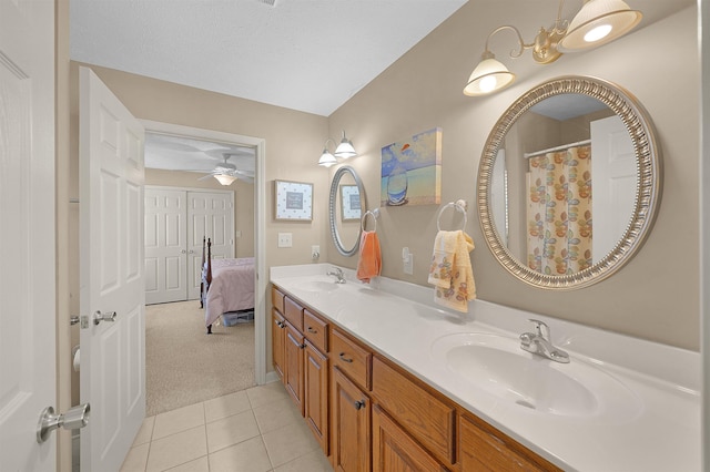 165 Ping Hill Dr, Counce, TN 38326 - ensuite bathroom with double vanity, a sink, ceiling fan, and tile patterned floors