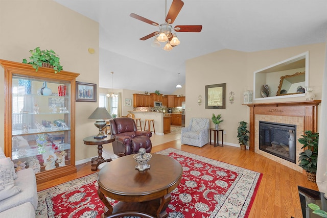 165 Ping Hill Dr, Counce, TN 38326 - living area with a ceiling fan, light wood finished floors, lofted ceiling, and a fireplace