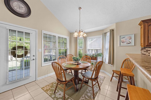 165 Ping Hill Dr, Counce, TN 38326 - dining area featuring light tile patterned floors, an inviting chandelier, and a healthy amount of sunlight