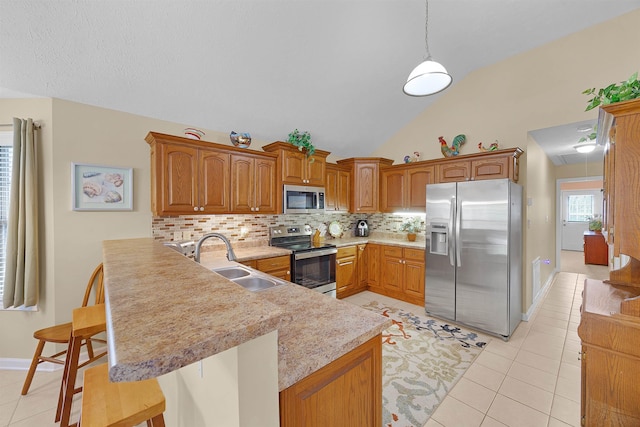 165 Ping Hill Dr, Counce, TN 38326 - kitchen featuring a sink, light countertops, a peninsula, stainless steel appliances, and light tile patterned flooring