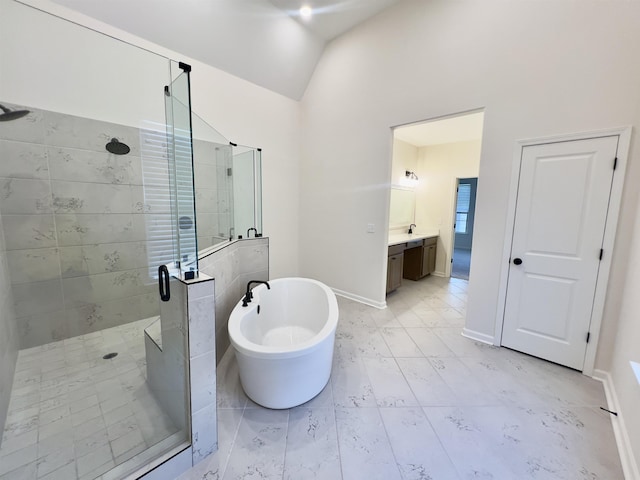 full bathroom featuring vanity, baseboards, lofted ceiling, a soaking tub, and a stall shower