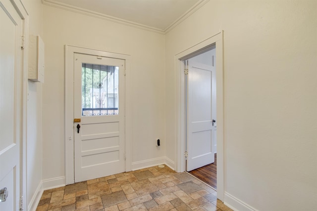 entryway featuring baseboards, ornamental molding, and stone finish floor