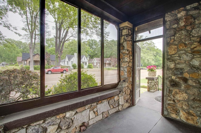 unfurnished sunroom with a residential view