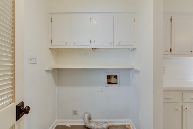clothes washing area with electric dryer hookup, hookup for a washing machine, cabinet space, and baseboards