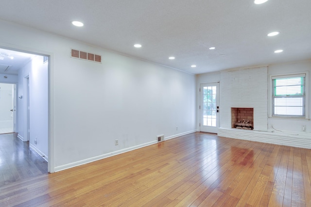 unfurnished living room with recessed lighting, baseboards, light wood-type flooring, and visible vents
