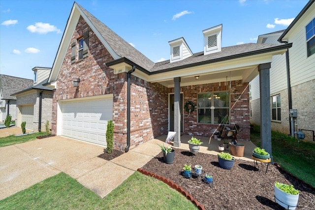 view of front of home with brick siding, driveway, and a garage