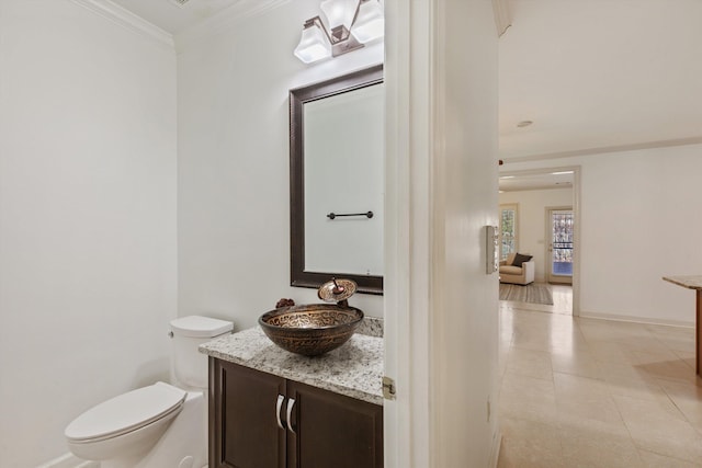 half bathroom featuring crown molding, toilet, tile patterned floors, and vanity