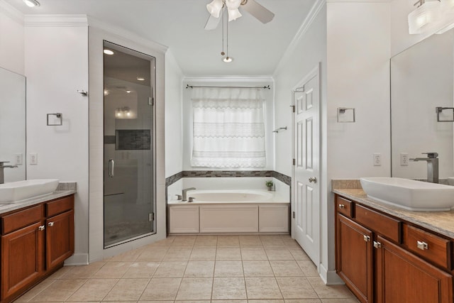 full bathroom featuring a sink, crown molding, a shower stall, and two vanities