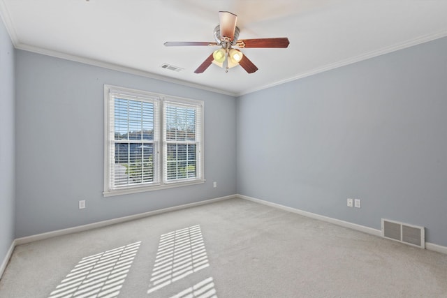 spare room with visible vents, carpet, crown molding, and baseboards