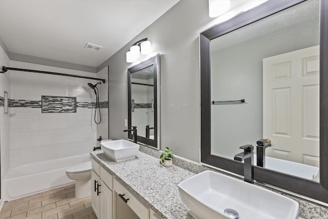 full bathroom with a sink, toilet, and visible vents